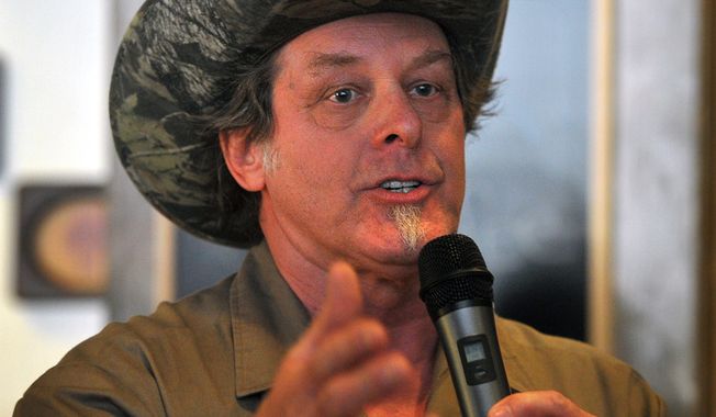 Longtime rocker Ted Nugent speaks to a crowd of Greg Abbott supporters during a campaign stop in Wichita Falls, Texas on Tuesday, Feb. 18, 2014. Abbott welcomed salty-tongued rocker Ted Nugent to his campaign for Texas governor on Tuesday but claimed ignorance about inflammatory remarks his polarizing surrogate has made on immigration and women. (AP Photo/Wichita Falls Times Record News, Torin Halsey)
