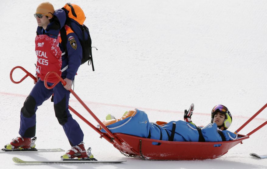 Andorra's Joan Verdu Sanchez is carried away by medics after he crashed in the first run of the men's giant slalom at the Sochi 2014 Winter Olympics, Wednesday, Feb. 19, 2014, in Krasnaya Polyana, Russia. (AP Photo/Gero Breloer)