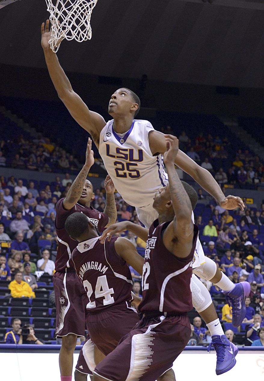 LSU's Jordan Mickey flies over Mississippi State players to score during an NCAA college basketball game Wednesday, Feb. 19, 2014, in Baton Rouge, La. (AP Photo/The Baton Rouge Advocate, Heather McClelland)