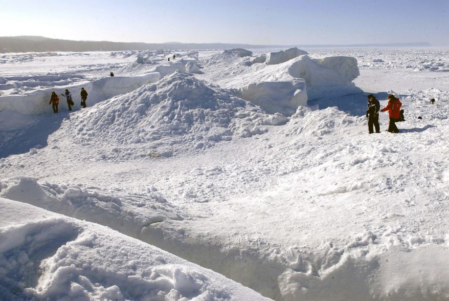 The frozen waters and snow of Lake Michigan have formed huge ice caves seen along the shore of northern Leelanau County, between Northport and Leland, Mich., on Wednesday, Feb. 19, 2014. Sub-zero temperatures in late December through mid-January, along with strong winds and heavy snowfall, created the ice ridges several hundred feet from shore. (AP Photo/John L. Russell)