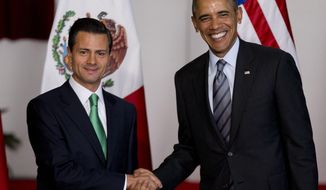 Mexico&#39;s President Enrique Pena Nieto, left, and President Barack Obama pose for photographers at the North American Leaders Summit in Toluca, Mexico, Wednesday, Feb. 19, 2014. Obama is in Toluca for the one-day summit with Mexican and Canadian leaders, meeting on issues of trade and other neighbor-to-neighbor interests, even as Congress is pushing back against some of his top cross-border agenda items. (AP Photo/Eduardo Verdugo)