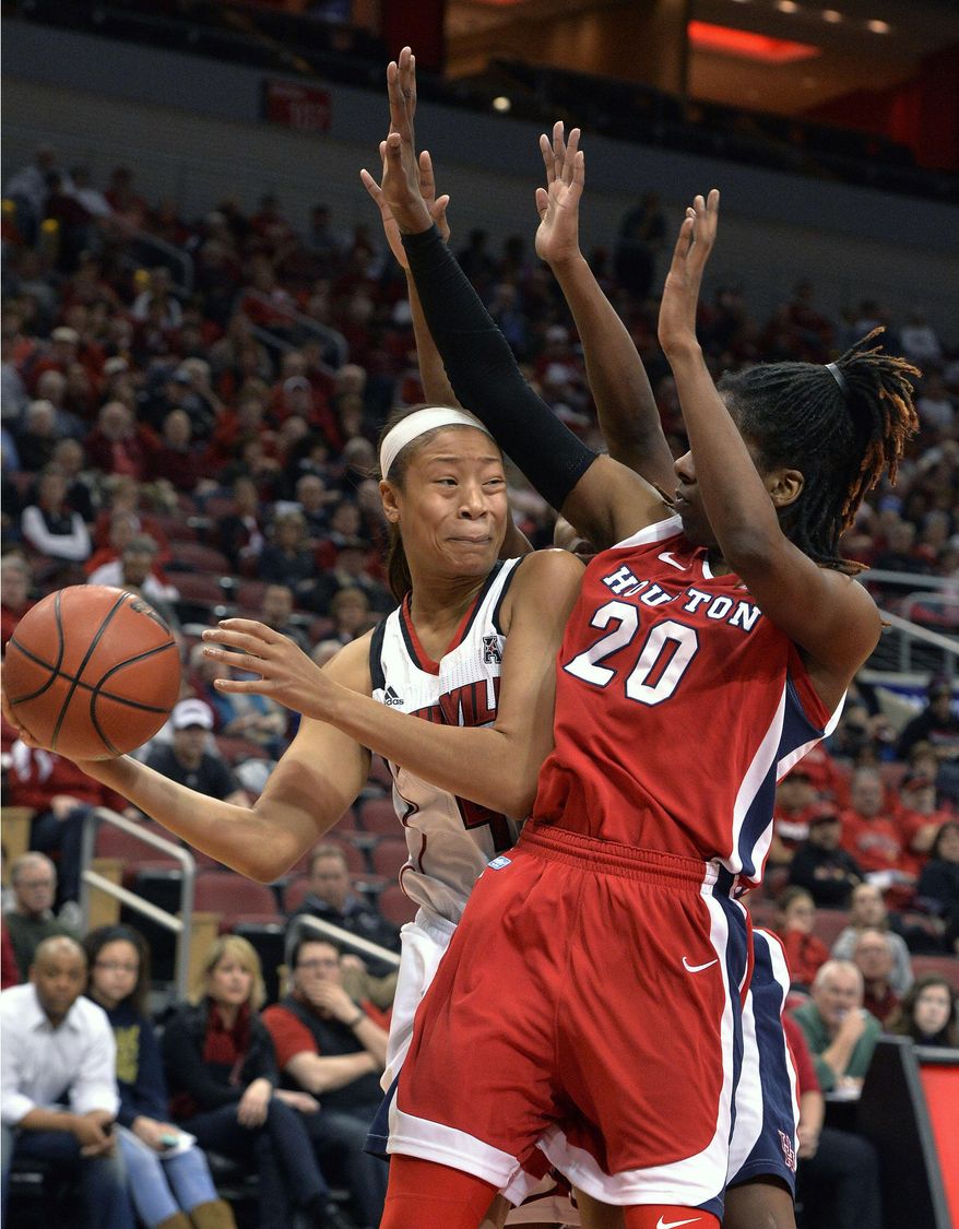 Louisville's Antonita Slaughter, left, attempts to pass around the defense of Houston's Yasmeen Thompson during the first half of an NCAA college basketball game Wednesday, Feb. 19, 2014, in Louisville, Ky. (AP Photo/Timothy D. Easley)