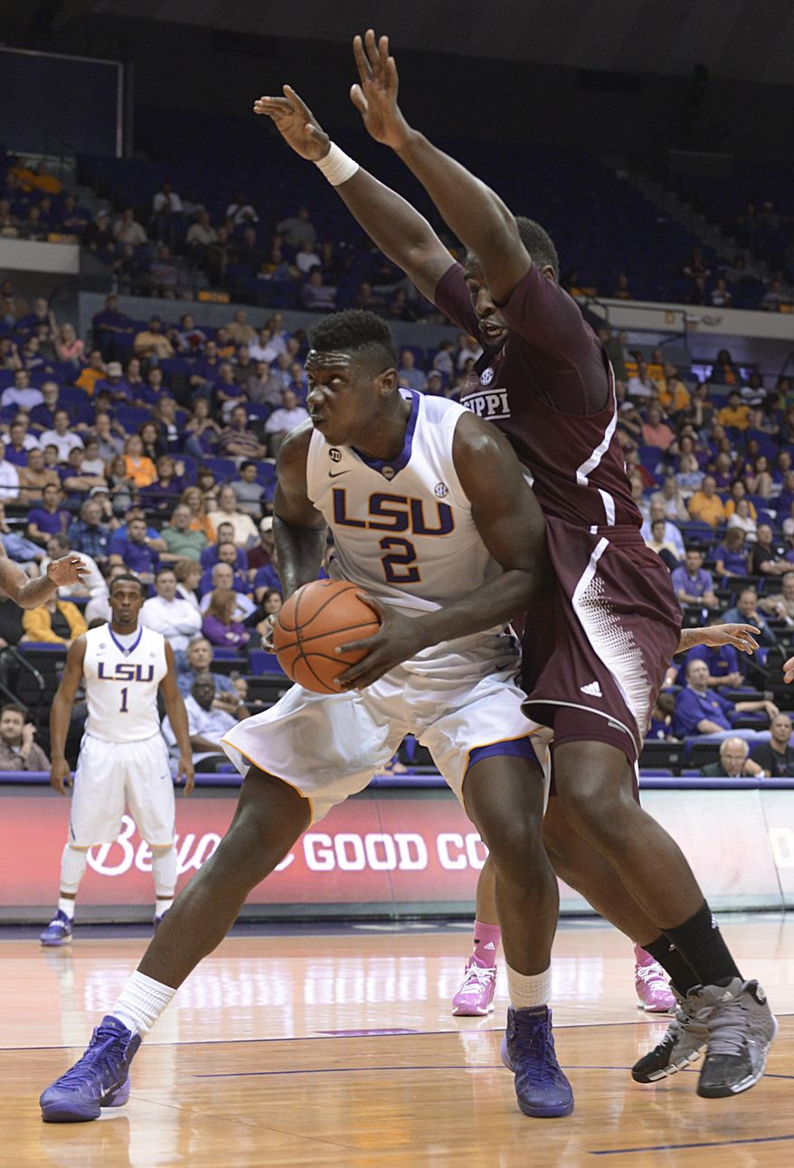 LSU's Johnny O'Bryant (2) tries to work around a Mississippi State defender for a shot during an NCAA college basketball game Wednesday, Feb. 19, 2014, in Baton Rouge, La. (AP Photo/The Baton Rouge Advocate, Heather McClelland)