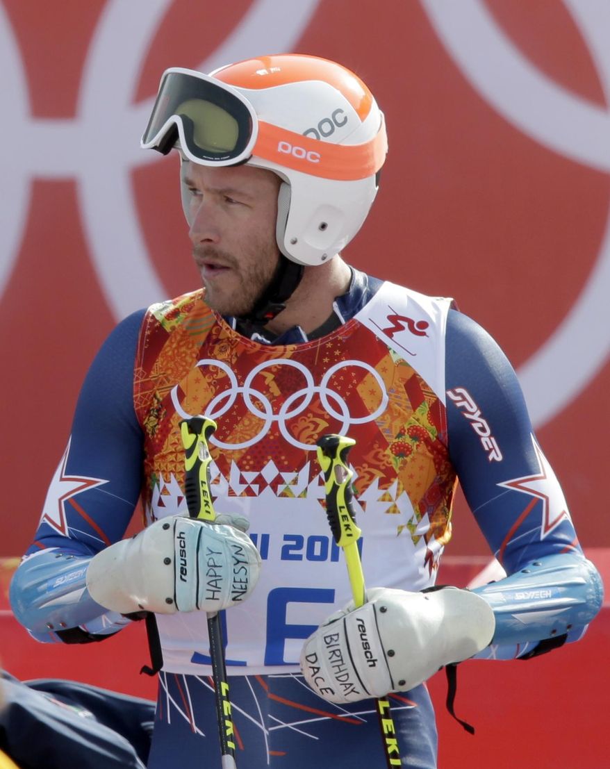 United States' Bode Miller wears gloves with a handwritten birthday greeting to his daughter, Neesyn, after finishing the second run in the men's giant slalom at the Sochi 2014 Winter Olympics, Wednesday, Feb. 19, 2014, in Krasnaya Polyana, Russia. (AP Photo/Gero Breloer)