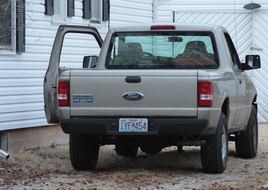 A truck is parked outside the home of Craig Michael Wood as police and FBI agents investigate the scene where Wood was arrested in Springfield, Mo., on Wednesday, Feb. 19, 2014. Woods was charged Wednesday with first-degree murder in the death of a 10-year-old girl. A body believed to be that of Hailey Owens was found Wednesday at the home owned by Wood, Police Chief Paul Williams said at a news conference. Official confirmation won't occur until after an autopsy, but Police Chief Paul Williams said "we have a high degree of confidence" in the preliminary identification. He did not disclose the child's cause of death. (AP Photo/The Springfield News-Leader, Dean Curtis) NO SALES