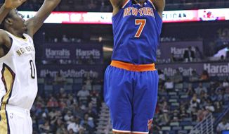 New York Knicks small forward Carmelo Anthony (7) shoots the ball over New Orleans Pelicans small forward Al-Farouq Aminu (0) during the first quarter of an NBA basketball game in New Orleans, Wednesday, Feb. 19, 2014. (AP Photo/Jonathan Bachman)