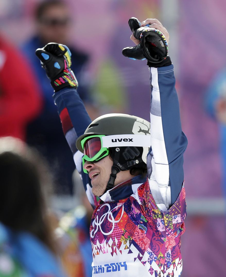 Russia's Vic Wild celebrates after winning the gold medal in the men's snowboard parallel giant slalom final at the Rosa Khutor Extreme Park, at the 2014 Winter Olympics, Wednesday, Feb. 19, 2014, in Krasnaya Polyana, Russia.(AP Photo/Andy Wong)