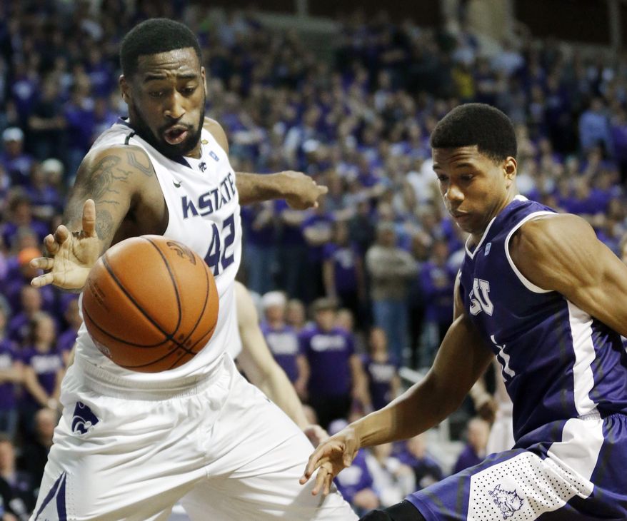 Kansas State forward Thomas Gipson (42) reaches for the ball while covered by TCU forward Brandon Parrish, right, during the first half of an NCAA college basketball game in Manhattan, Kan., Wednesday, Feb. 19, 2014. (AP Photo/Orlin Wagner)