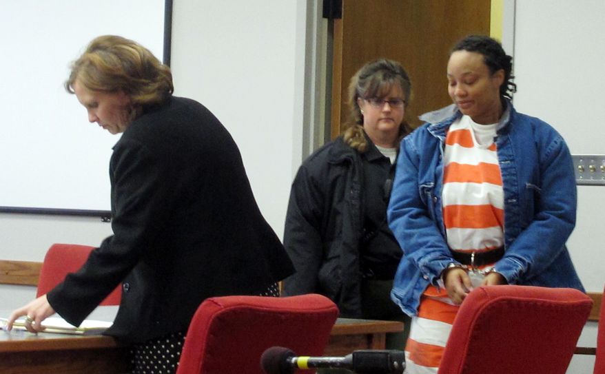 In this Feb. 14, 2014 photo Kristen Smith, arrives for a hearing in Tipton, Iowa. A federal grand jury has indicted Smith and her accused of kidnapping her half sister's newborn in Wisconsin and leaving him behind an Iowa gas station. (AP Photo/Ryan J. Foley)