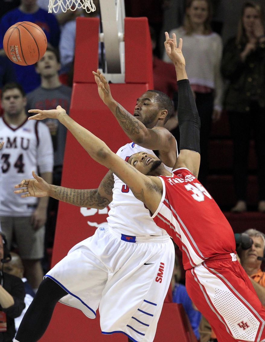 SMU forward Markus Kennedy (5) and Houston forward TaShawn Thomas (35) stretch out while attempting to grab a loose ball during the first half of  an NCAA basketball game on Wednesday, Feb. 19, 2014, in Dallas. (AP Photo/John F. Rhodes)