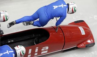 The team from Italy ITA-1, piloted by Simone Bertazzo, start a run during the men&#39;s four-man bobsled training at the 2014 Winter Olympics, Wednesday, Feb. 19, 2014, in Krasnaya Polyana, Russia. (AP Photo/Michael Sohn)