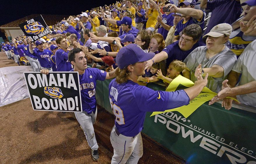 ADVANCE FOR WEEKEND EDITIONS, FEB. 22-23 - FILE - In this June 8, 2013 file photo, Chris Chinea (20) and closing pitcher Chris Cotton (58) thanks the fans as the LSU team makes the circuit around the stadium after an NCAA college baseball tournament super regional game against Oklahoma, in Baton Rouge, La. SEC teams have played in the championship game in each of the last six years, with three _ LSU in 2009, and South Carolina in 2010 and '11 _ winning it all. (AP Photo/Bill Feig, File)