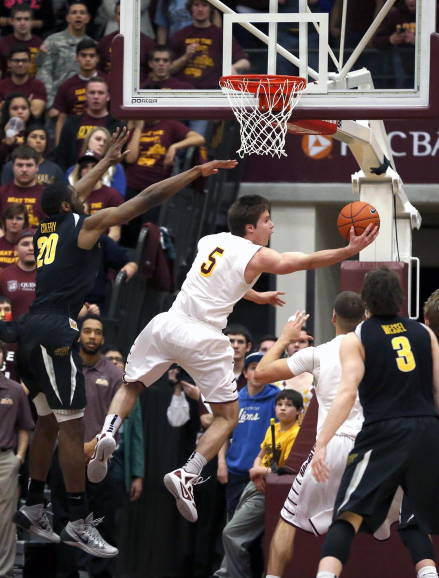 Loyola of Chicago guard Joe Crisman (5) shoots and scores past Wichita State center Kadeem Coleby (20) during the first half of an NCAA college basketball game Wednesday, Feb. 19, 2014, in Chicago. (AP Photo/Charles Rex Arbogast)