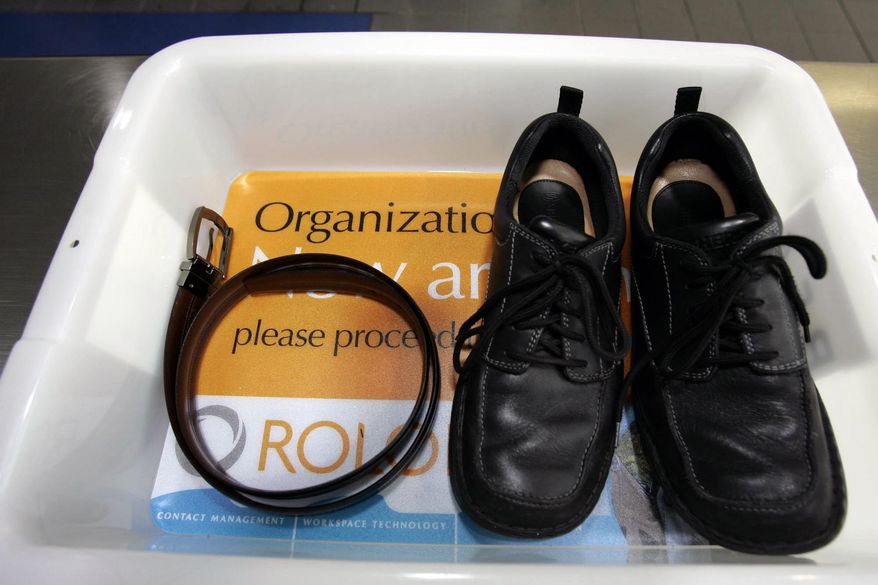 In this Wednesday, Jan. 10, 2007, file photo, a belt and shoes sit in a trays with advertising that is being used in the safety screening of travelers done by the Transportation Security Administration, at the Los Angeles International Airport in Los Angeles. (AP Photo/Ann Johansson, File)