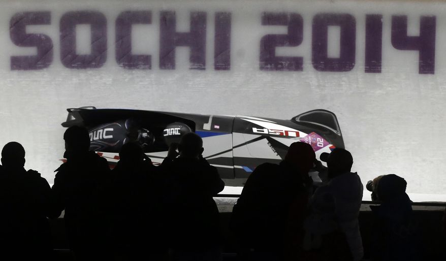 The team from the United States USA-1, piloted by Elana Meyers with brakeman Lauryn Williams, take a curve in the third run during the women's bobsled competition at the 2014 Winter Olympics, Wednesday, Feb. 19, 2014, in Krasnaya Polyana, Russia. (AP Photo/Dita Alangkara)