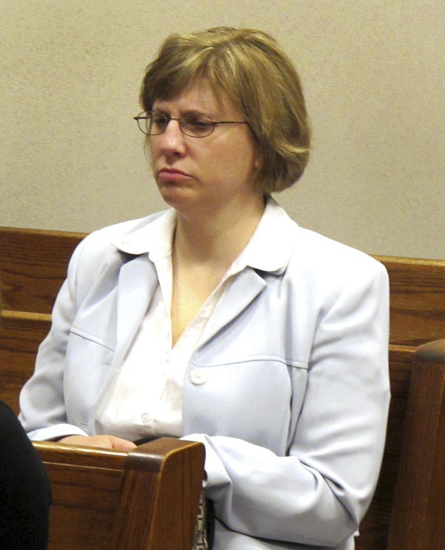 FILE - In this March 20, 2012 file photo Kelly Rindfleisch sits in a Milwaukee County courtroom. A Wisconsin state appeals court on Wednesday, Feb. 19, 2014 released thousands of emails and other previously sealed documents collected during a criminal investigation into Rindfleisch, a former aide to Republican Gov. Scott Walker. (AP Photo/Dinesh Ramde, File)