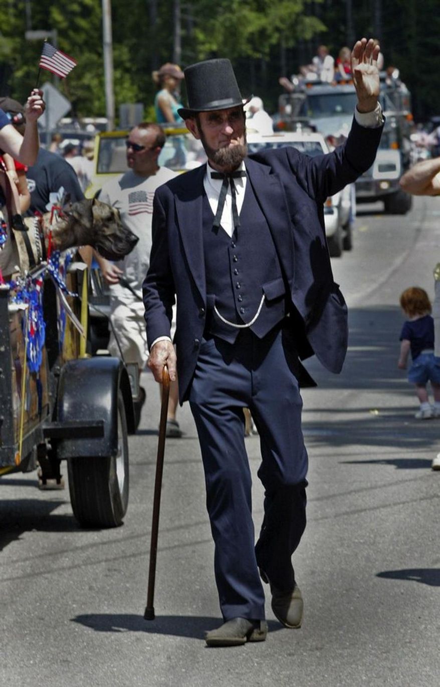 FILE In this July 4, 2009 file photo, Robert Brown dressed like Abraham Lincoln, greets parade goers in Tahuya, Wash. Brown, who portrayed Abraham Lincoln at the Armed Forces Day Parade and other patriotic events passed away Feb. 12, the 16th president's birthday. Brown lived in a cabin without power and water on 5 acres above Tahuya. He suffered a brain abscess on New Year's Day, underwent surgery at Harborview Medical Center in Seattle and was recovering at Life Care Center in Port Orchard when a seizure took his life, said former wife Rena Farrar. He was 72. (AP Photo/Kitsap Sun, Steve Zugschwerdt)