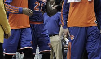 New York Knicks shooting guard Iman Shumpert (21) is helped off the court after being injured during the second half of an NBA basketball game against the New Orleans Pelicans in New Orleans, Wednesday, Feb. 19, 2014. The Knicks won 98-91. (AP Photo/Jonathan Bachman)