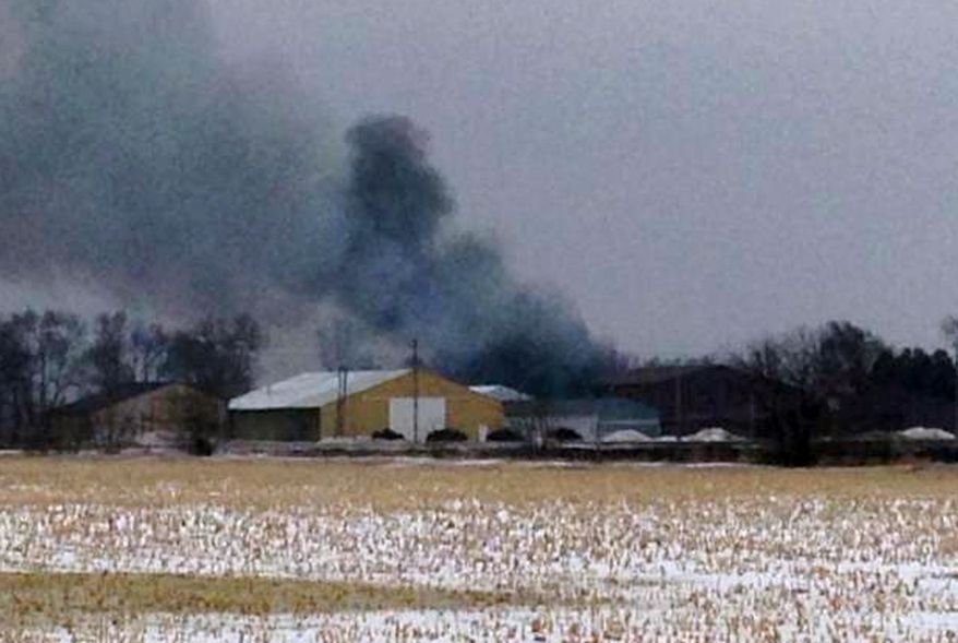 In this image from video provided by KIMT-TV is smoke rises from a fire in Northwood, Iowa, Thursday, Feb. 20, 2014. Authorities say an evacuation order is in place for Northwood due to a fire at a fertilizer plant at Northwood Municipal Airport. No one is reported injured. (AP Photo/KIMT-TV, Levi Ismail)