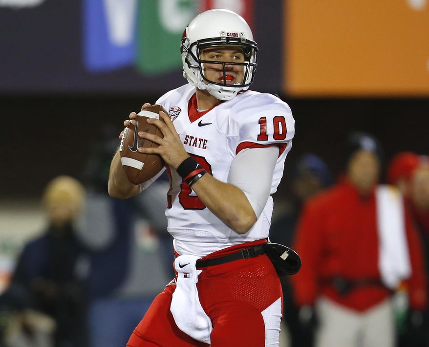 FILE - This Nov. 13, 2013 file photo shows Ball State quarterback Keith Wenning (10) looking to pass during the first half of an NCAA college football game against Northern Illinois in DeKalb, Ill. Wenning and Northern Illinois quarterback Jordan Lynch have already forgotten about their college rivalry. On Wednesday, Feb. 19, 2014, the two quarterbacks find themselves working toward the same goal and pushing one another as training partners and friends. (AP Photo/Jeff Haynes, file)
