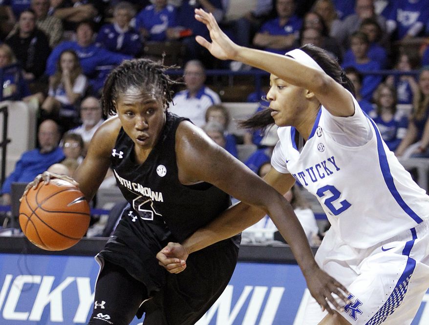 South Carolina's Aleighsa Welch, left, drives to the basket as Kentucky's Jelleah Sidney defends during the first half of an NCAA college basketball game, Thursday, Feb. 20, 2014, in Lexington, Ky. (AP Photo/James Crisp)