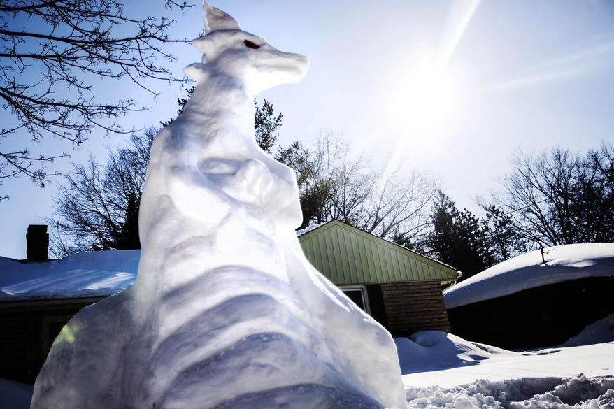 A snowdragon sits on the lawn of Mike Huver on Thursday, Feb. 20, 2014 in Kalamazoo, Mich. Huver sways it took him five hours to build the snowdragon. (AP Photo/Kalamazoo Gazette-MLive Media Group, Chuck Miller ) ALL LOCAL TV OUT; LOCAL TV INTERNET OUT