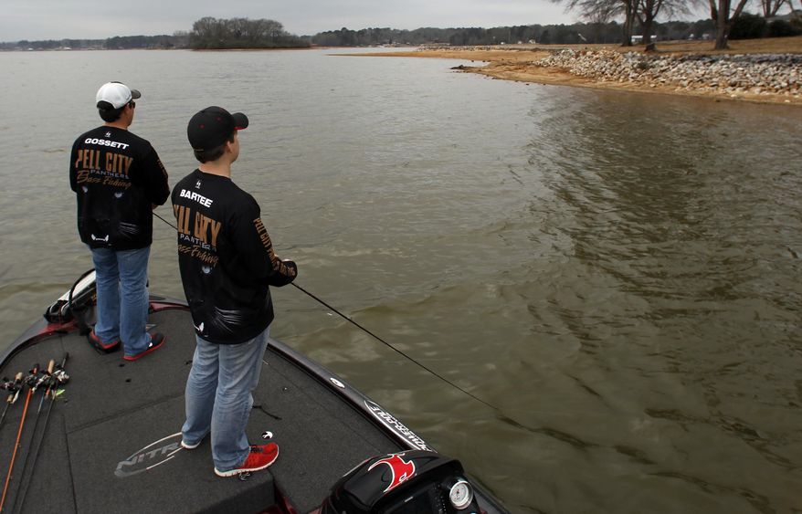 In this Tuesday, Feb. 18, 2014 photo, Pell City Panthers Bass Fishing team members, Zeke Gossett, left, and Hayden Bartee, right, fish on Logan Martin lake in Pell City, Ala. The first B.A.S.S. High School Classic Exhibition Saturday, Feb. 22, 2014 is just the latest example of the rise in opportunities for teens to compete on the lakes. High school anglers from five states will get to weigh in on the same Alabama stage as the pros in this weekend’s Bassmaster Classic. (AP Photo/Butch Dill)
