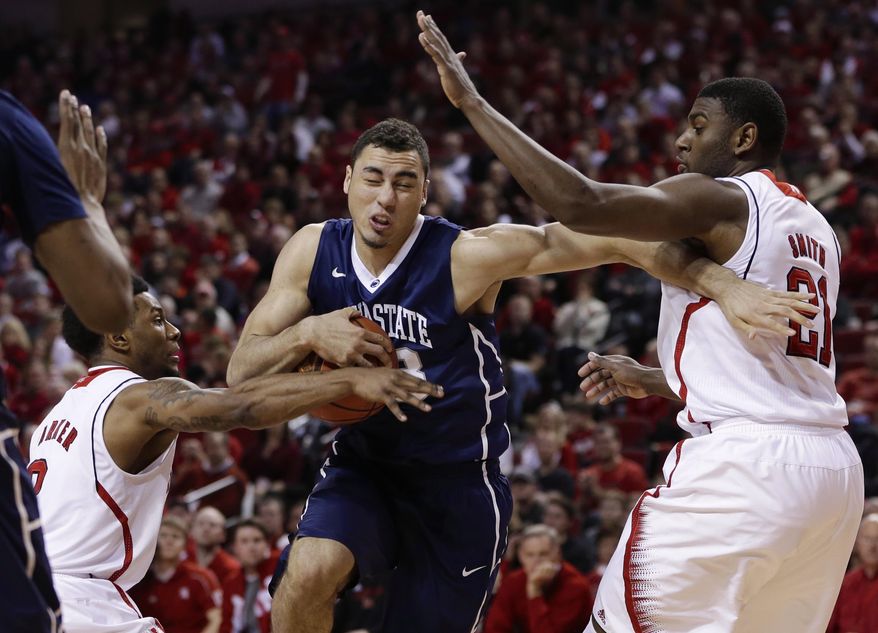 Penn State's Ross Travis, center, drives to the basket against Nebraska's Benny Parker, left, and Nebraska's Leslee Smith (21) in the first half of an NCAA college basketball game in Lincoln, Neb., Thursday, Feb. 20, 2014. (AP Photo/Nati Harnik)