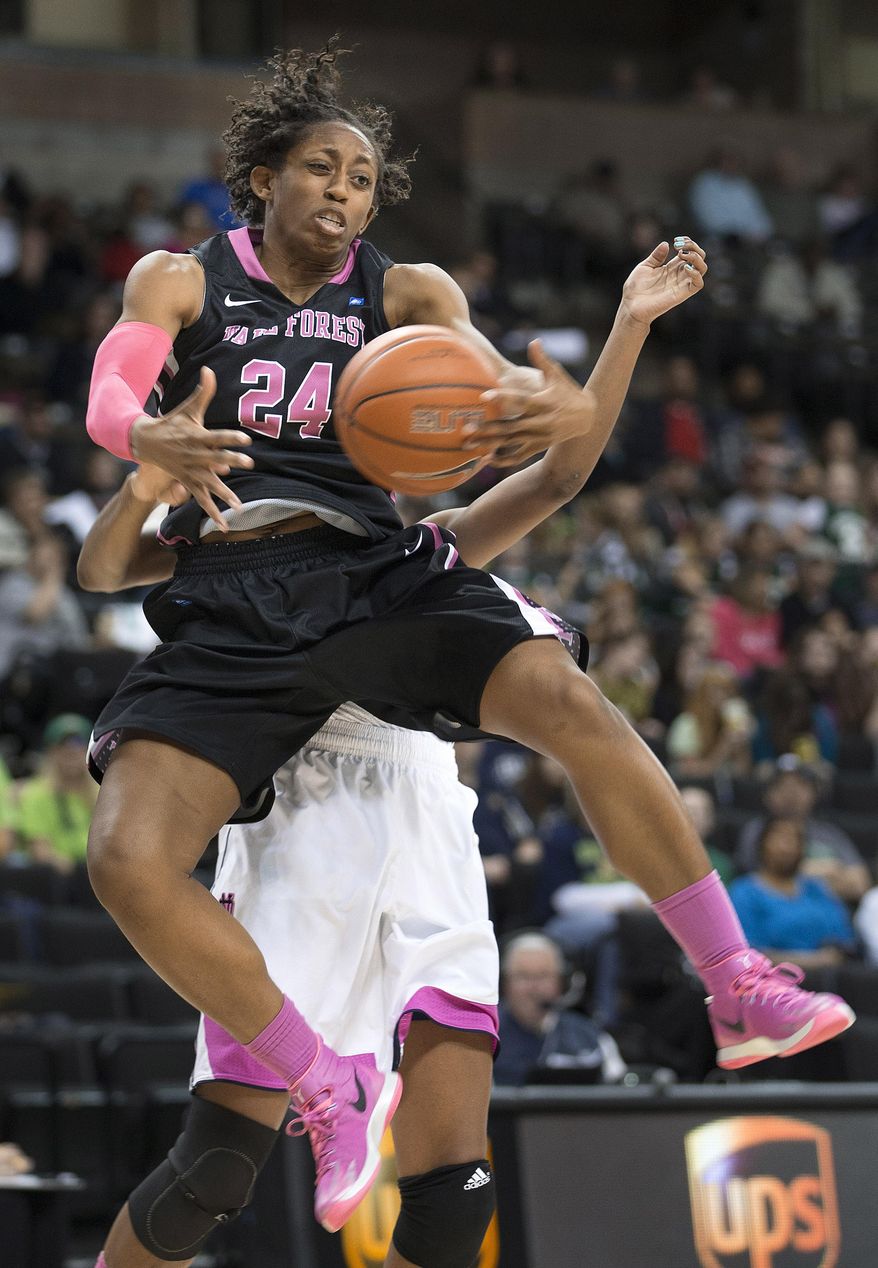 Wake Forest's  Kelila Atkinson (24) gets a rebound in front on Notre Dame's  Ariel Braker during the second half of an NCAA college basketball game Thursday, Feb. 20, 2014, in Winston-Salem, N.C. Notre Dame won 86-61.(AP Photo/Lynn Hey)
