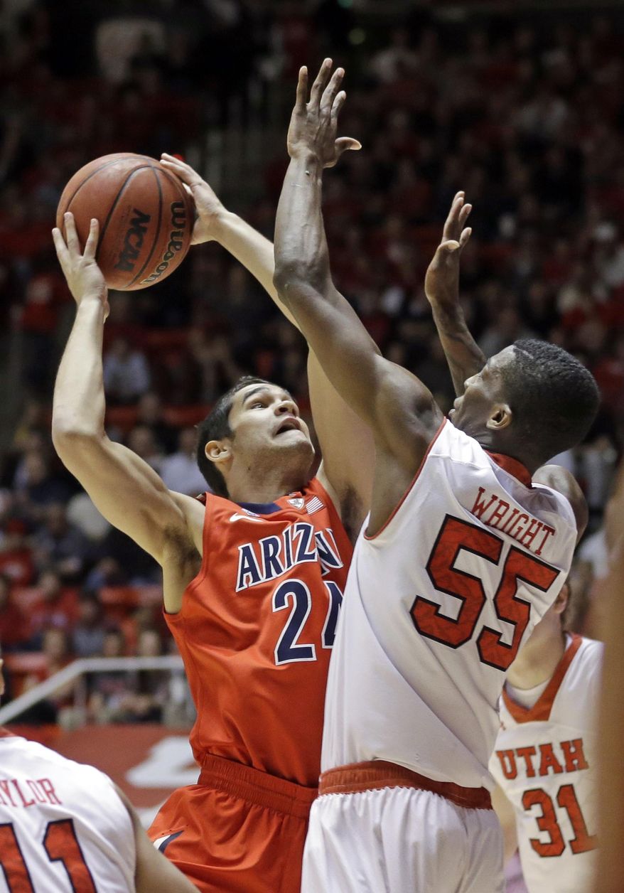 Arizona's Elliott Pitts (24) shoots as Utah's Delon Wright (55) defends in the first half of an NCAA college basketball game, Wednesday, Feb. 19, 2014, in Salt Lake City. (AP Photo/Rick Bowmer)