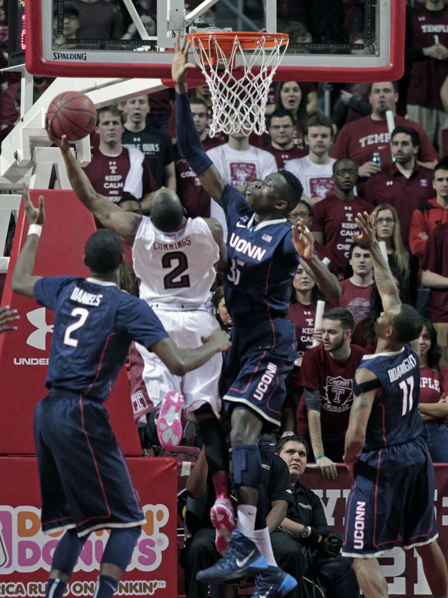 Connecticut's Amida Brimah (35) defends as Temple's Will Cummings (2) goes up for a shot in the first half of an NCAA college basketball game, Thursday, Feb. 20, 2014 in Philadelphia. (AP Photo/H. Rumph Jr.)