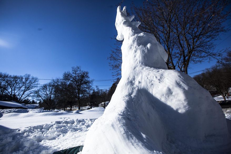 A snowdragon sits on the lawn of Mike Huver on Thursday, Feb. 20, 2014 in Kalamazoo, Mich. Huver sways it took him five hours to build the snowdragon. (AP Photo/Kalamazoo Gazette-MLive Media Group, Chuck Miller ) ALL LOCAL TV OUT; LOCAL TV INTERNET OUT
