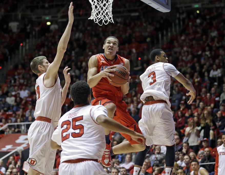 Arizona's Aaron Gordon, center, goes to the basket while Utah's Renan Lenz, left, Kenneth Ogbe (25) and Princeton Onwas (3) defend in the first half of an NCAA college basketball game, Wednesday, Feb. 19, 2014, in Salt Lake City. (AP Photo/Rick Bowmer)