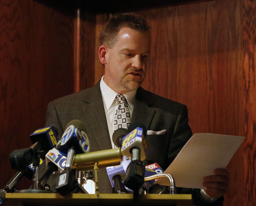 Scott Wilhelm, attorney for eight New Jersey high school wrestlers scratched from a state tournament days after a photo surfaced of team members apparently simulating a lynching, reads a statement on behalf of his clients at a news conference on Thursday, Feb. 20, 2014 in Philipsburg , N.J. The photo features seven Philipsburg High School wrestlers apparently simulating a lynching of a black wrestling dummy in a rival team's shirt. (AP Photo/Rich Schultz)