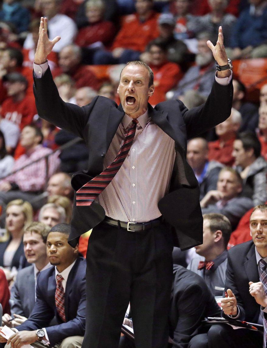 Utah head coach Larry Krystkowiak shouts to his team in the first half of an NCAA college basketball game against Arizona, Wednesday, Feb. 19, 2014, in Salt Lake City. (AP Photo/Rick Bowmer)