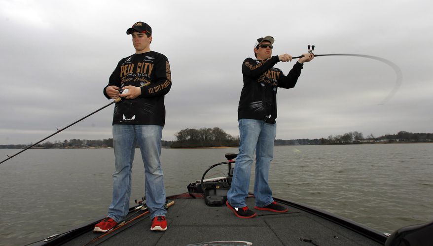 In this Tuesday, Feb. 18, 2014 photo, Pell City Panthers Bass Fishing team members, Hayden Bartee, left, and Zeke Gossett, right, fish on Logan Martin lake in Pell City, Ala. The first B.A.S.S. High School Classic Exhibition Saturday, Feb. 22, 2014 is just the latest example of the rise in opportunities for teens to compete on the lakes. High school anglers from five states will get to weigh in on the same Alabama stage as the pros in this weekend’s Bassmaster Classic. (AP Photo/Butch Dill)