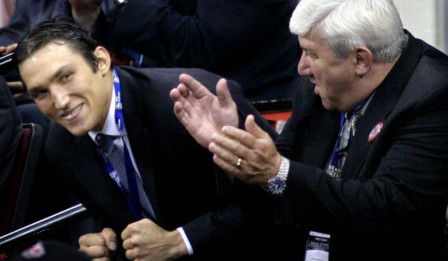 **FILE** Alexander Ovechkin, left, of Russia reacts after being selected as the first overall pick by the Washington Capitals during the NHL Draft, Saturday, June 26, 2004, at the RBC Center in Raleigh, N.C. At right is Ovechkin&#x27;s father Mikhail Ovechkin. (AP Photo/Grant Halverson)