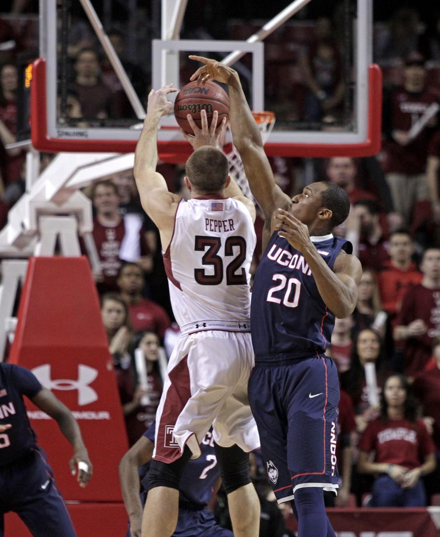 Connecticut's Lasan Kromah (20) blocks a shot by Temple's Dalton Pepper (32) in the first half of an NCAA college basketball game, Thursday, Feb. 20, 2014 in Philadelphia. (AP Photo/H. Rumph Jr.)