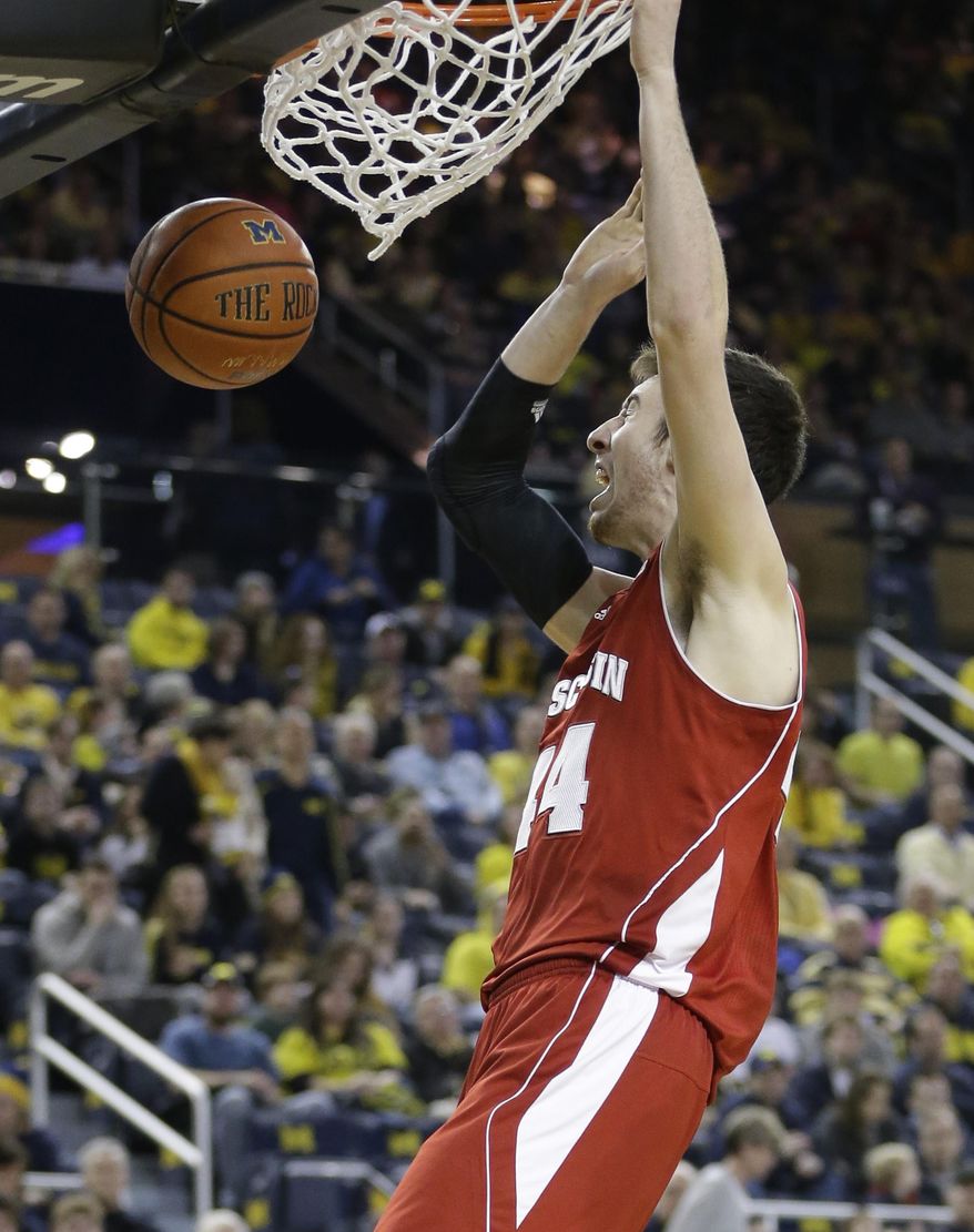 Wisconsin forward Frank Kaminsky (44) dunks during the second half of an NCAA college basketball game against Michigan in Ann Arbor, Mich., Sunday, Feb. 16, 2014. Kaminsky finished with 25 points in the Badgers 75-62 win. (AP Photo/Carlos Osorio)
