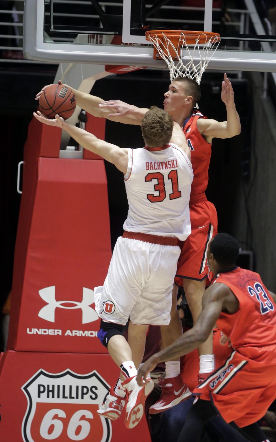 Arizona's Kaleb Tarczewski, rear, blocks the shot of Utah's Dallin Bachynski (31) in the first half of an NCAA college basketball game, Wednesday, Feb. 19, 2014, in Salt Lake City. (AP Photo/Rick Bowmer)