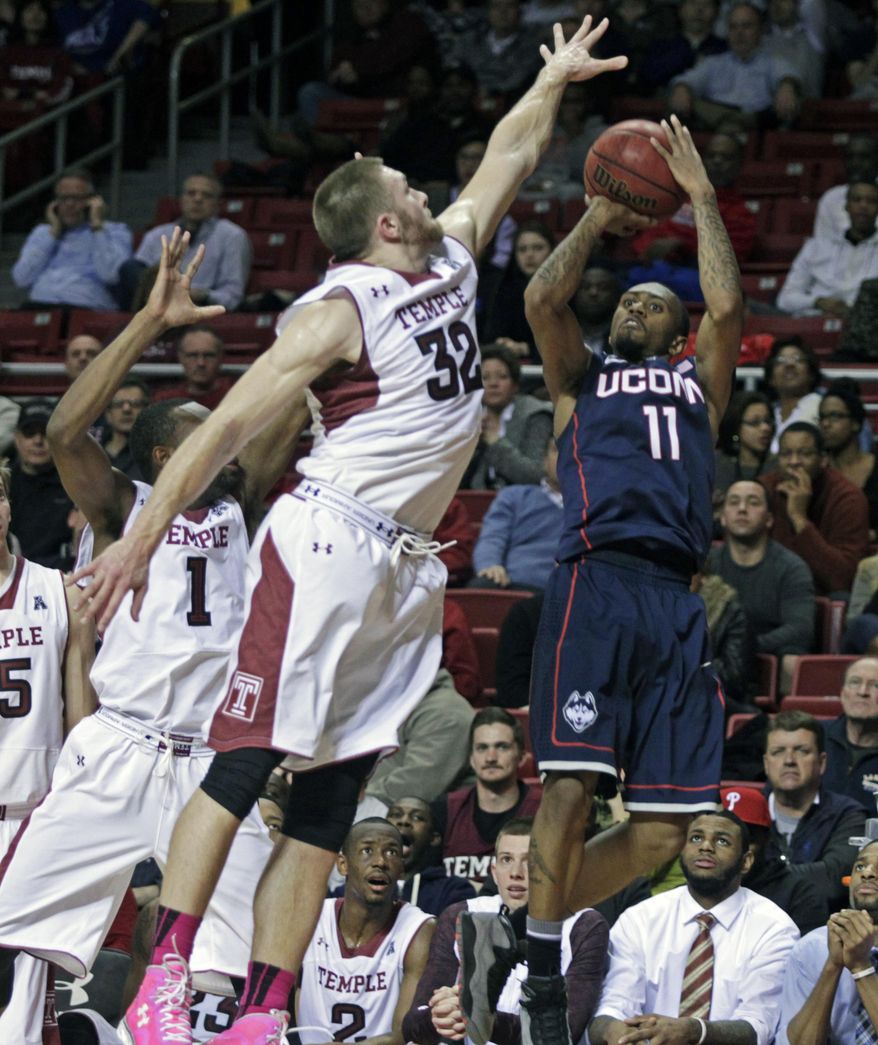 Connecticut's Ryan Boatright (11) shoots as Temple's Dalton Pepper (32) defends in the first half of an NCAA college basketball game, Thursday, Feb. 20, 2014 in Philadelphia. (AP Photo/H. Rumph Jr.)