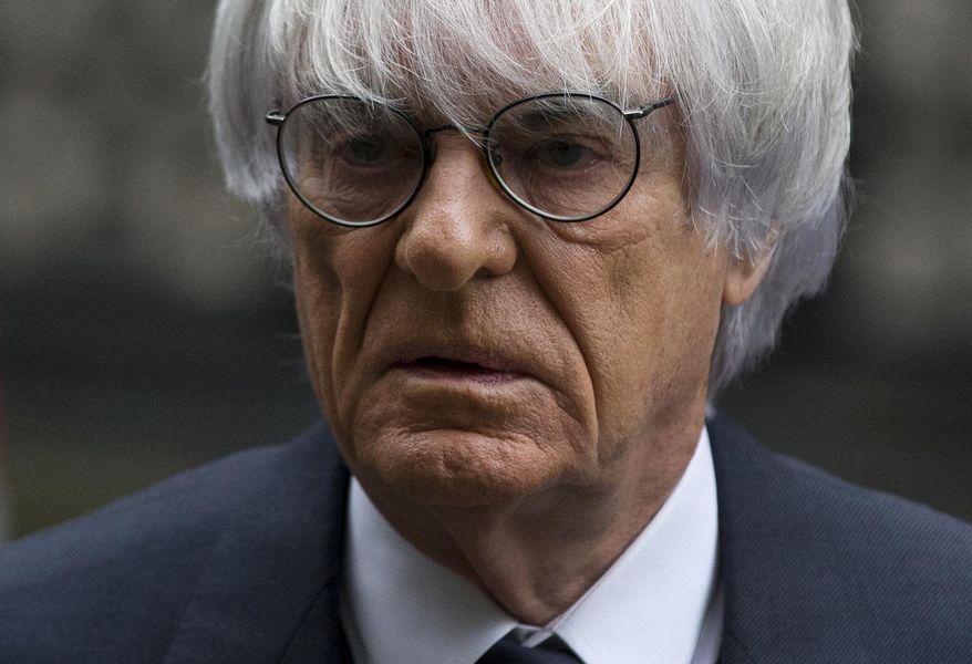 FILE - In this Nov. 11, 2013 file picture President and CEO of Formula One Management Bernie Ecclestone arrives for his case at the High Court in London. Formula 1 boss Bernie Ecclestone has won a multimillion-dollar case at London's High Court Thursday Feb. 20, 2014,relating to the sale of F1 in 2005 but the judge nevertheless said it was a corrupt deal. A former F1 shareholder, German media company Constantin Medien, had sued Ecclestone and other defendants for up to $144 million, claiming F1 was undervalued at the time of the sale to investment group CVC Capital Partners. (AP Photo/Matt Dunham. File)
