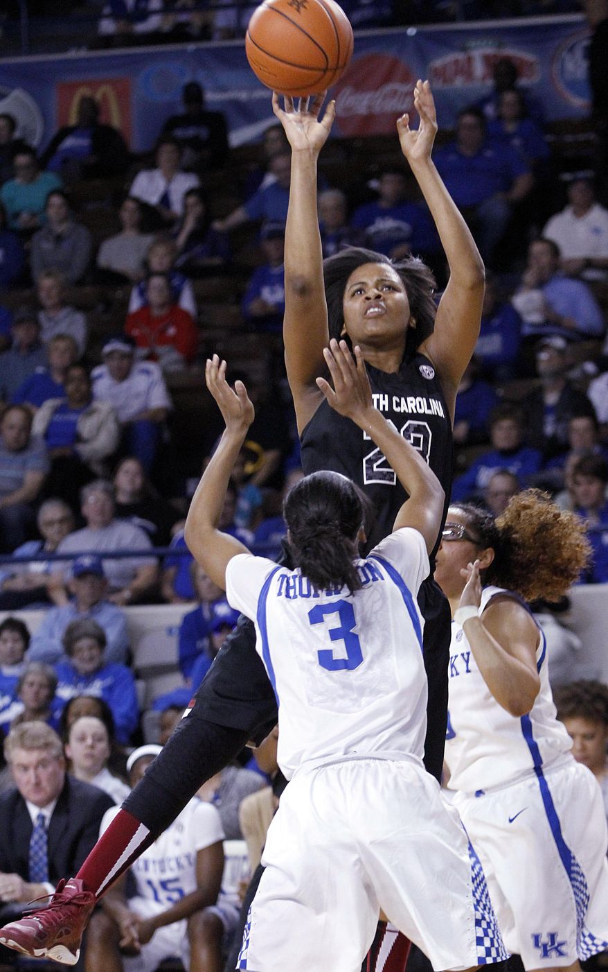 South Carolina's Tina Roy, top, shots between Kentucky's Janee Thompson (3) and Jennifer O'Neill during the first half of an NCAA college basketball game, Thursday, Feb. 20, 2014, in Lexington, Ky. (AP Photo/James Crisp)