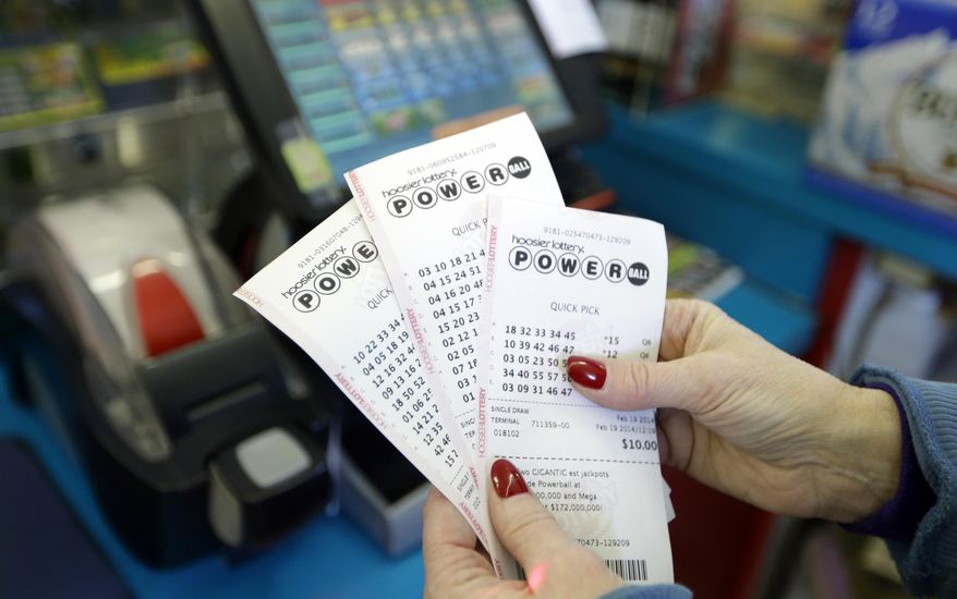 Regina Jeffers prepares to give a customer $50 in Powerball tickets at Buck's Super Market in Indianapolis, Wednesday, Feb. 19, 2014. Wednesday’s Powerball drawing carries a potential $400 million-plus jackpot. Buck's Super Market is the state's top lottery retailer. (AP Photo/Michael Conroy)