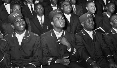ADVANCE FOR USE SUNDAY, FEB. 23, 2014 AND THEREAFTER - FILE - In this Feb. 28, 1966 file photo, Muhammad Ali listens to Elijah Muhammad as he speaks to other black Muslims in Chicago. (AP Photo/Paul Cannon)