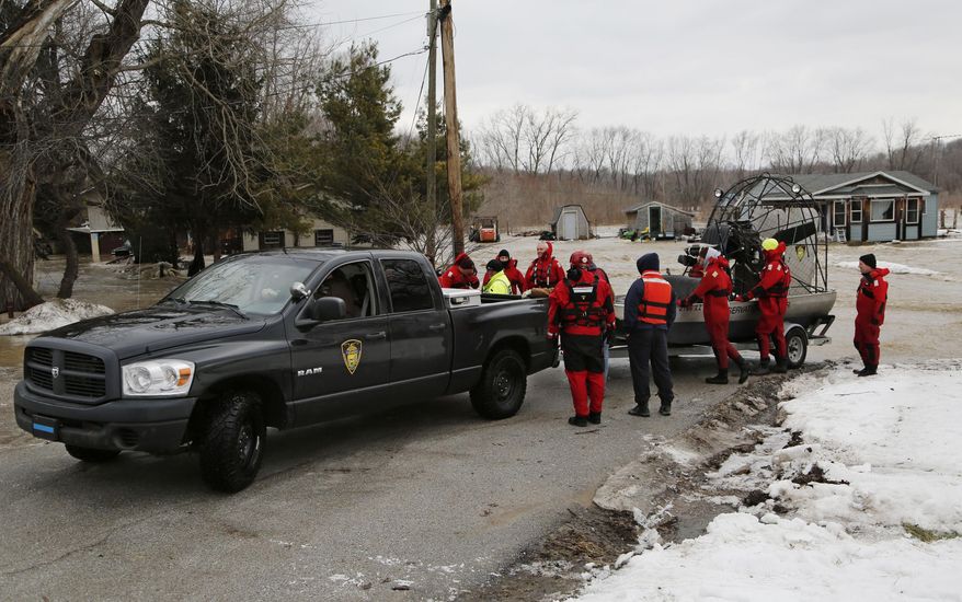 Indiana Conservation Officers and other rescue personnel pack up their gear after evacuating residents Friday, Feb. 21, 2014, on Barton Beach Road in Lafayette, Ind. Authorities say an ice jam has caused a creek near Lafayette to overflow its banks, flooding several homes and prompting some evacuations. (AP Photo/Journal & Courier, John Terhune)