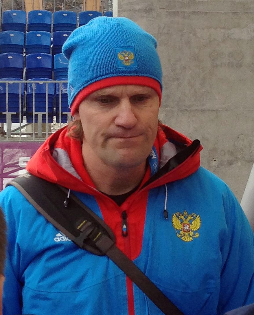 Russian bobsled coach Pierre Lueders speaks to reporters in the mixed zone during a training run for the men's four-man bobsled at the 2014 Winter Olympics, Friday, Feb. 21, 2014, in Krasnaya Polyana, Russia. (AP Photo/Tom Withers)