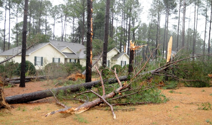 Residents filled their yards moments after what officials are calling a tornado touched down in the Holly Hills subdivision in northern Dublin and Laurens County, Ga. at around 8:30 a.m. Friday morning. Early reports show little to no injuries were suffered, but damage, like that seen at this house located off Woodland Trails Road, was extensive and impacted more than 50 houses. (AP Photo/The Courier Herald, Jason Halcombe)