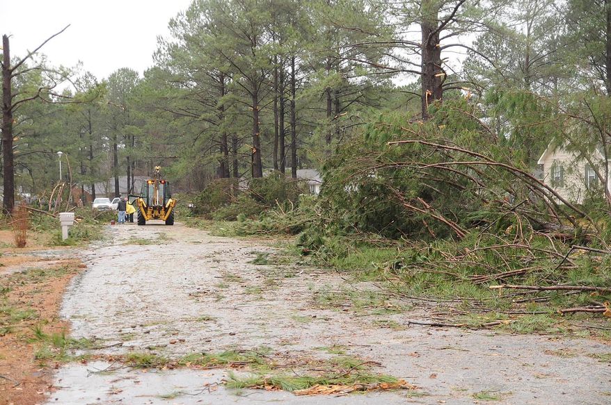 Crews work in the aftermath of the storm that hit in the Holly Hill subdivision in northern Laurens County, Ga. on Friday, Feb. 21, 2014. More than 50 homes were impacted by what officials are labeling a "severe weather event." (AP Photo/The Courier Herald, Jason Halcombe)