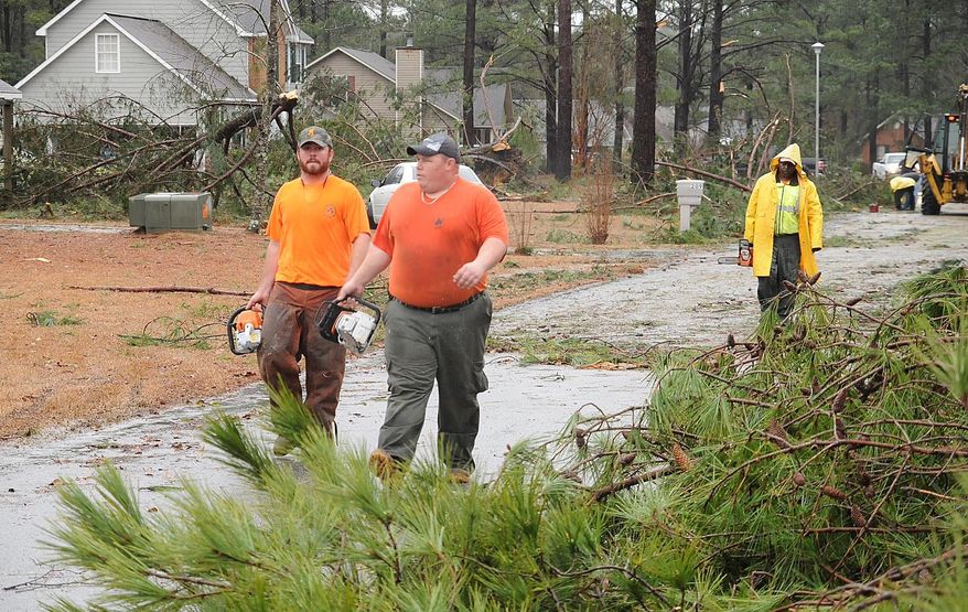 Crews work in the aftermath of the storm that hit in the Holly Hill subdivision in northern Laurens County, Ga. on Friday, Feb. 21, 2014. More than 50 homes were impacted by what officials are labeling a "severe weather event." (AP Photo/The Courier Herald, Jason Halcombe)
